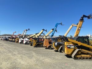 A person examines a rental contract and reviews equipment in a garage or workshop setting.
